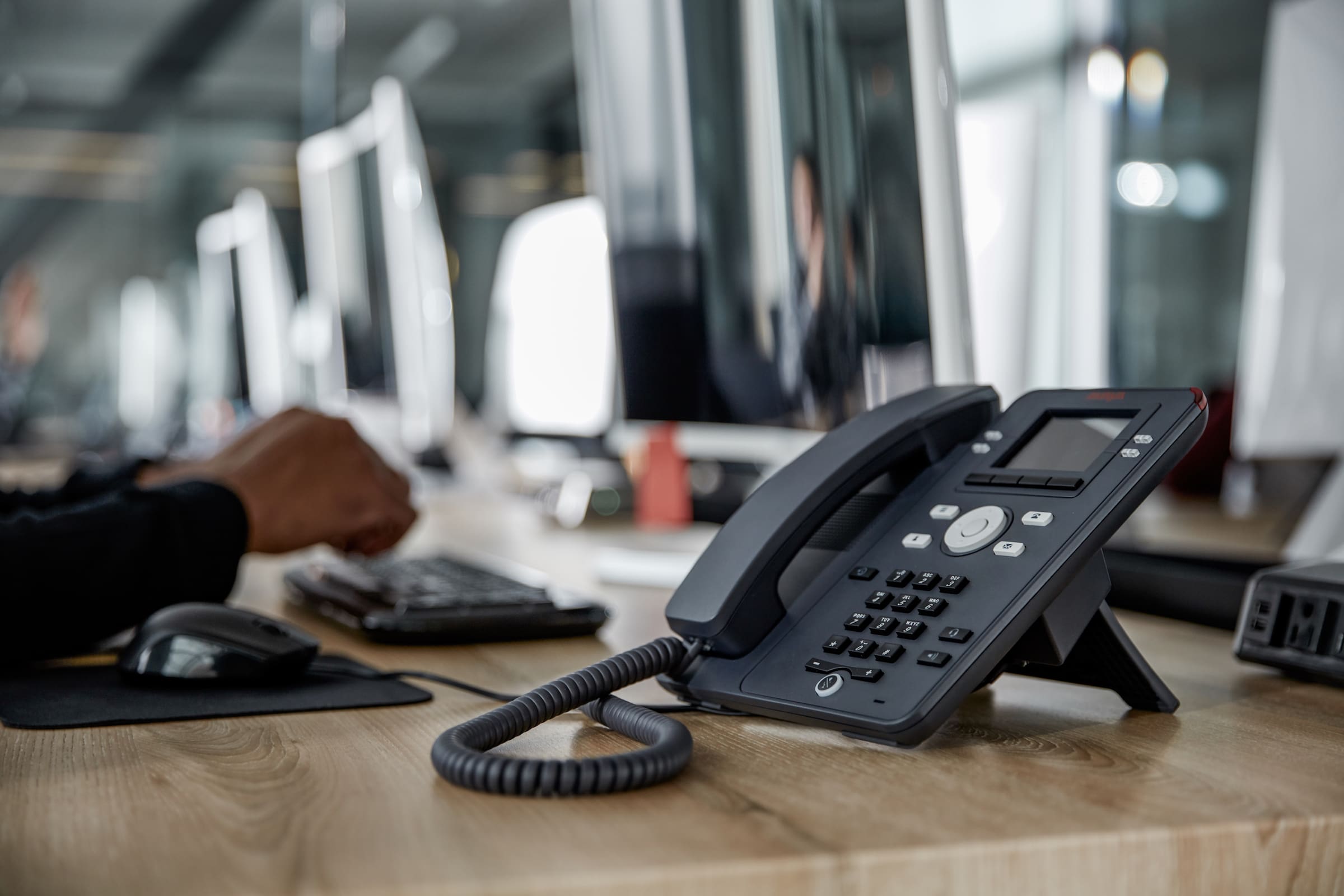An Avaya J139 phone set sitting on an office desk